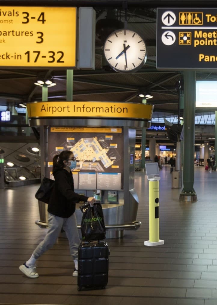 Traveller passing the scanning point at the Schiphol train station plaza